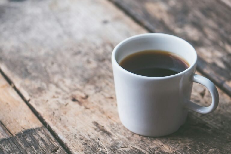 Cup of black coffee on a wooden table