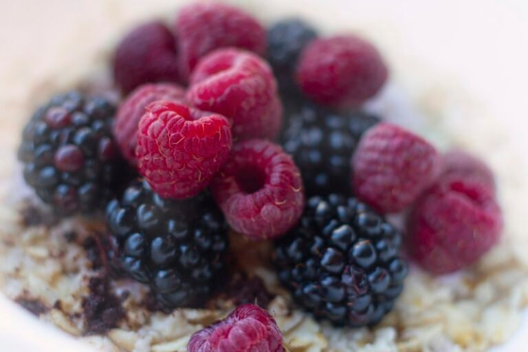 Bowl of oatmeal topped with raspberries and blackberries