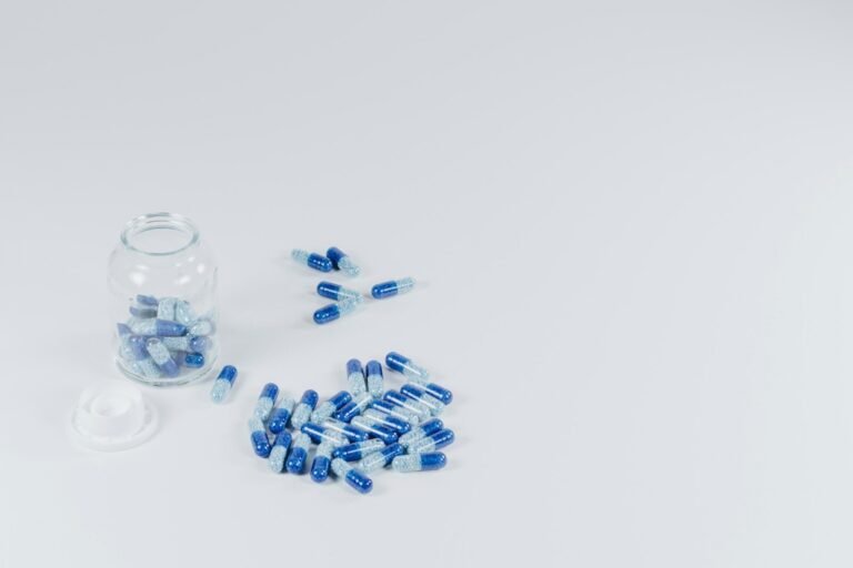 Supplement capsules beside a jar